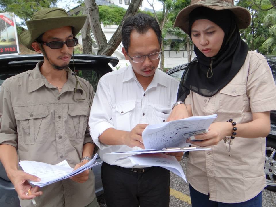 Navy team studying a large map in a park